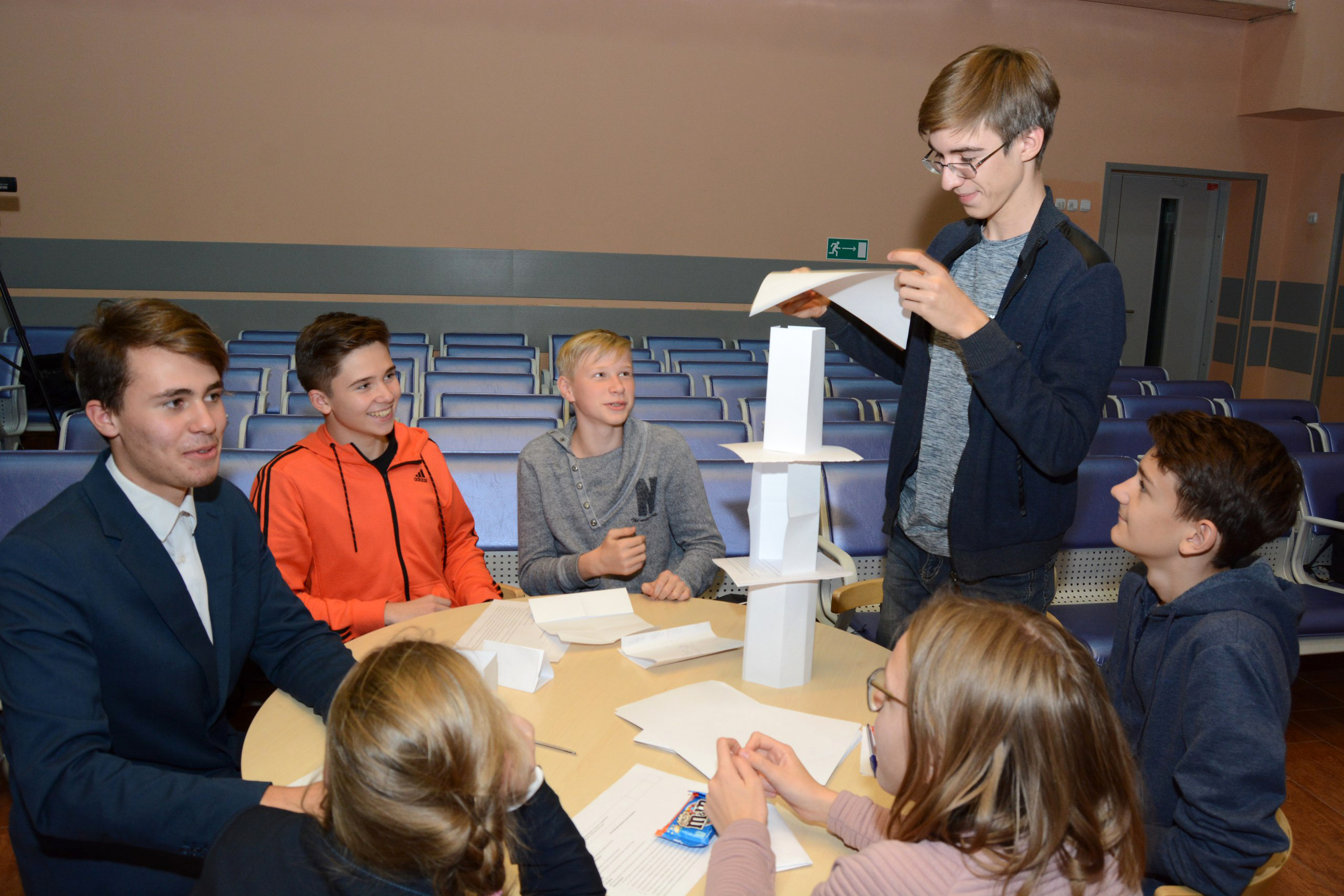 Students at ISI School build a paper tower as part of a phenomenon-based learning approach..