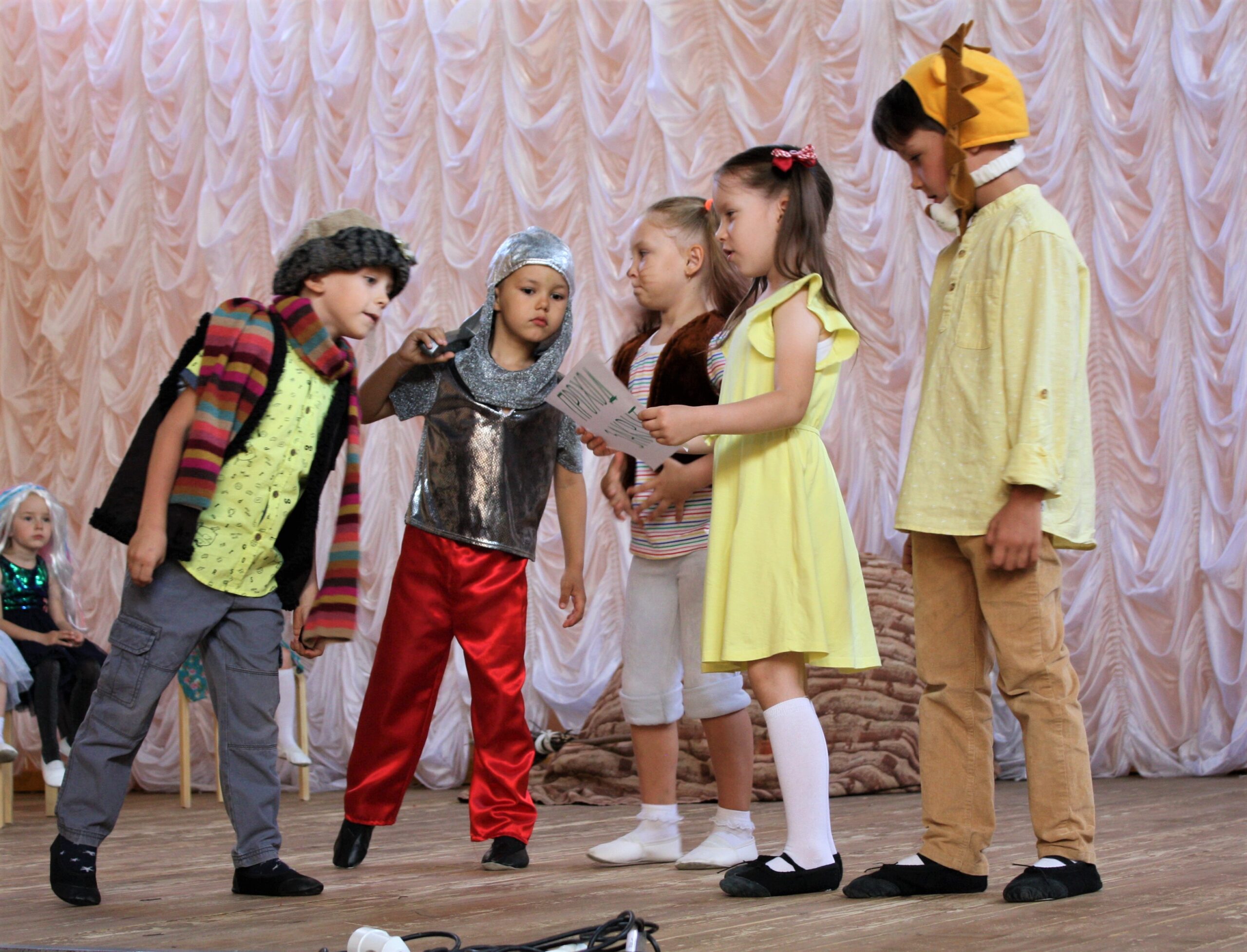 Children in costumes participate in a school play performance