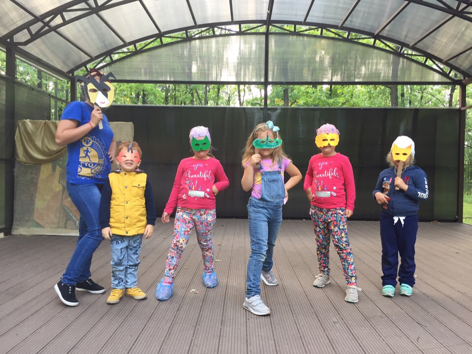 Children wearing masks on a play area in the camping site