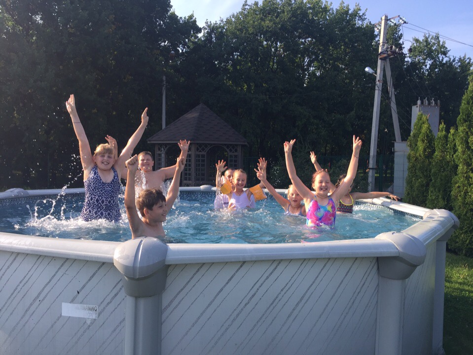 Children having fun splashing in an outdoor pool