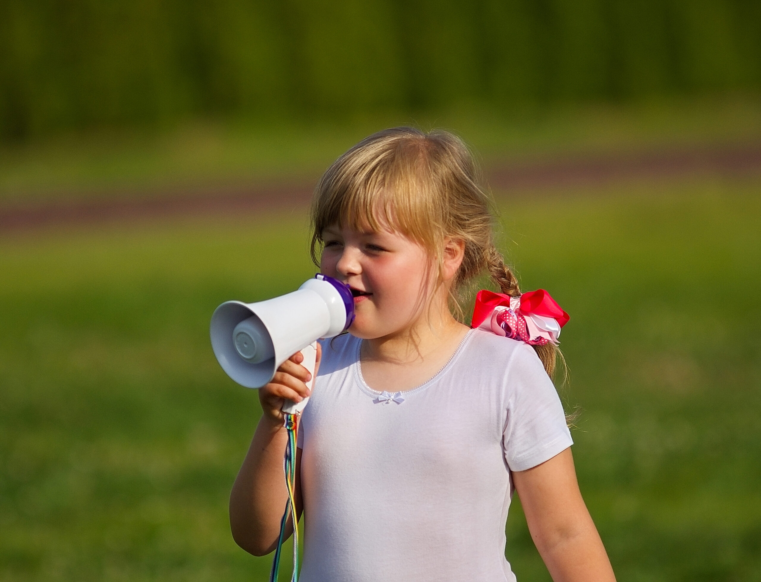 Girl with a megaphone at a school outdoor event