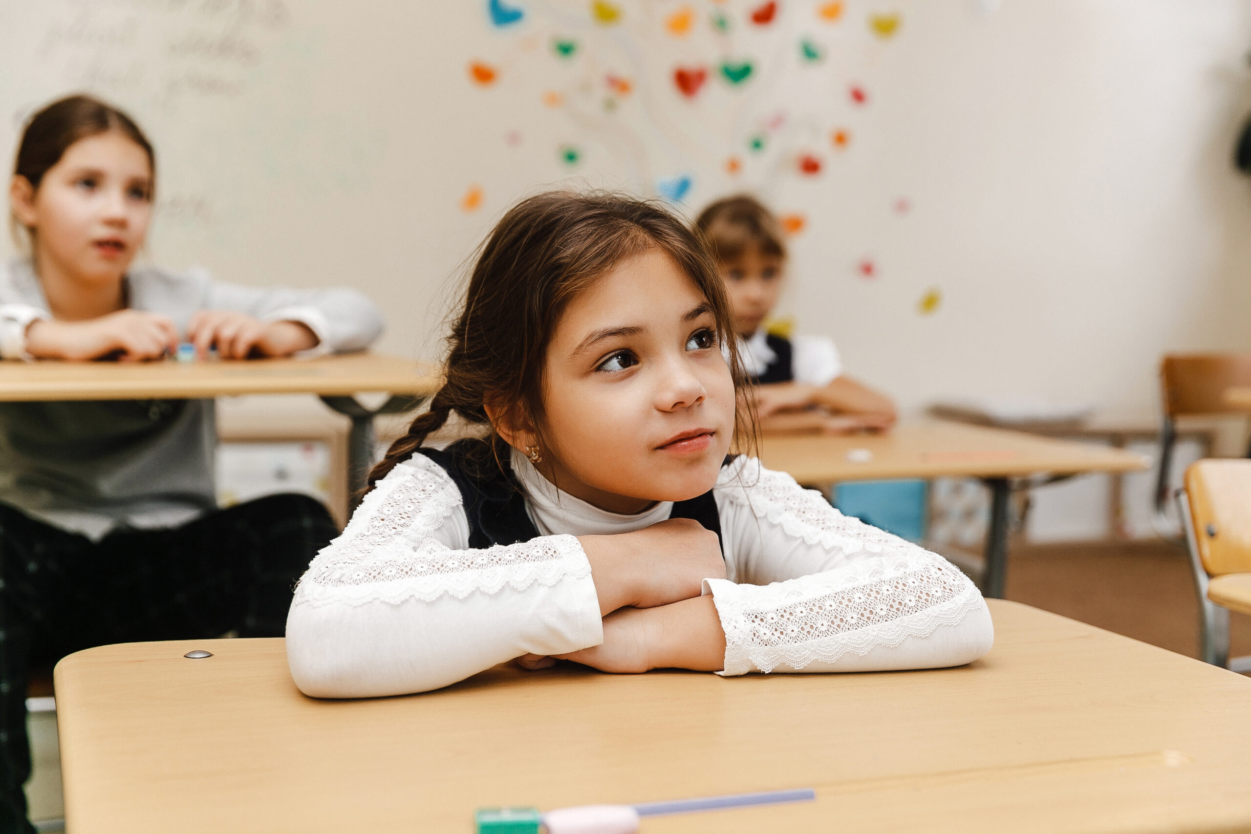 Girl student thoughtfully listening in classroom lesson
