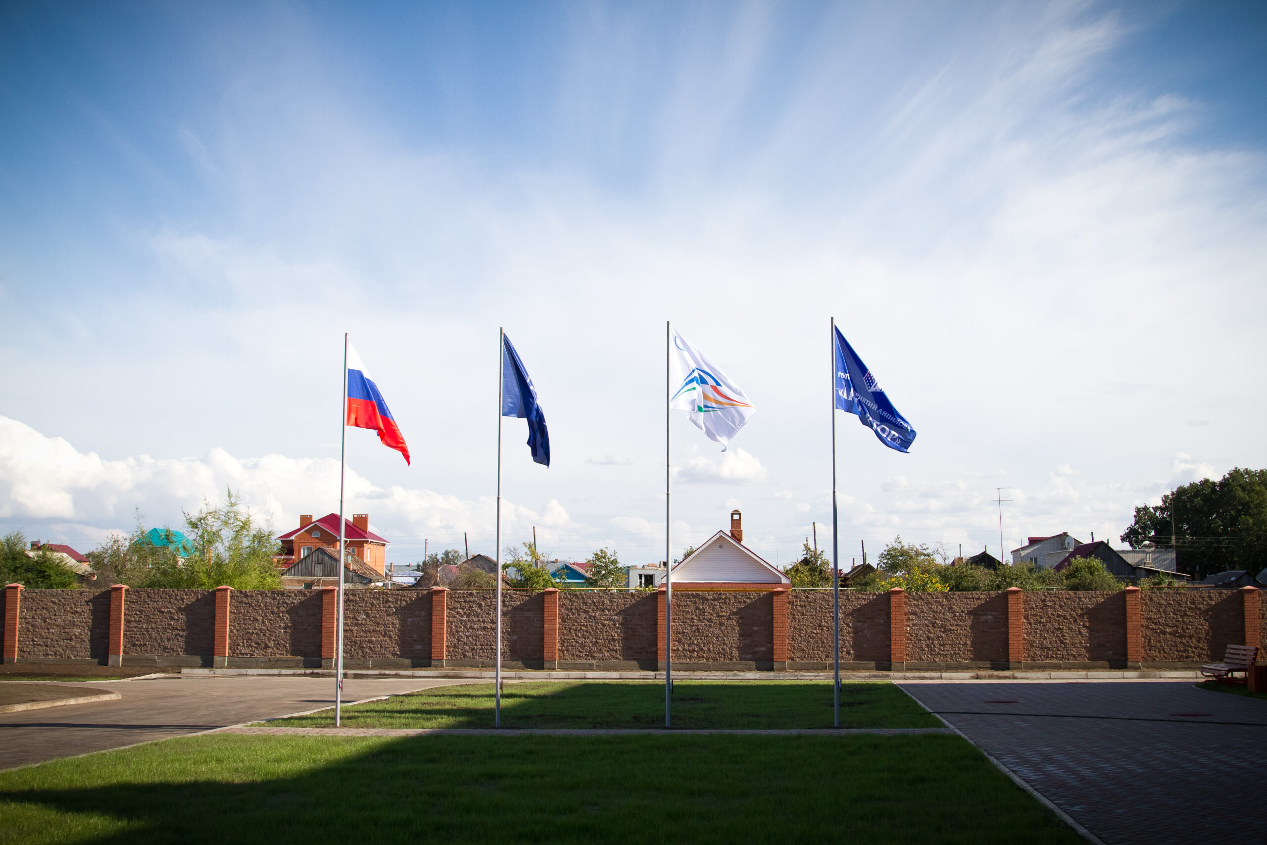 Flags on the territory of the istochnik school against the sky
