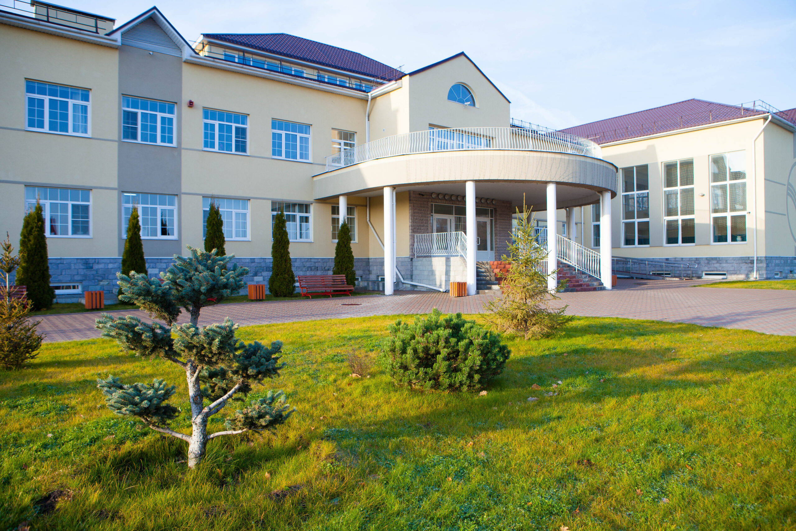 Modern educational building with green landscaped area at school