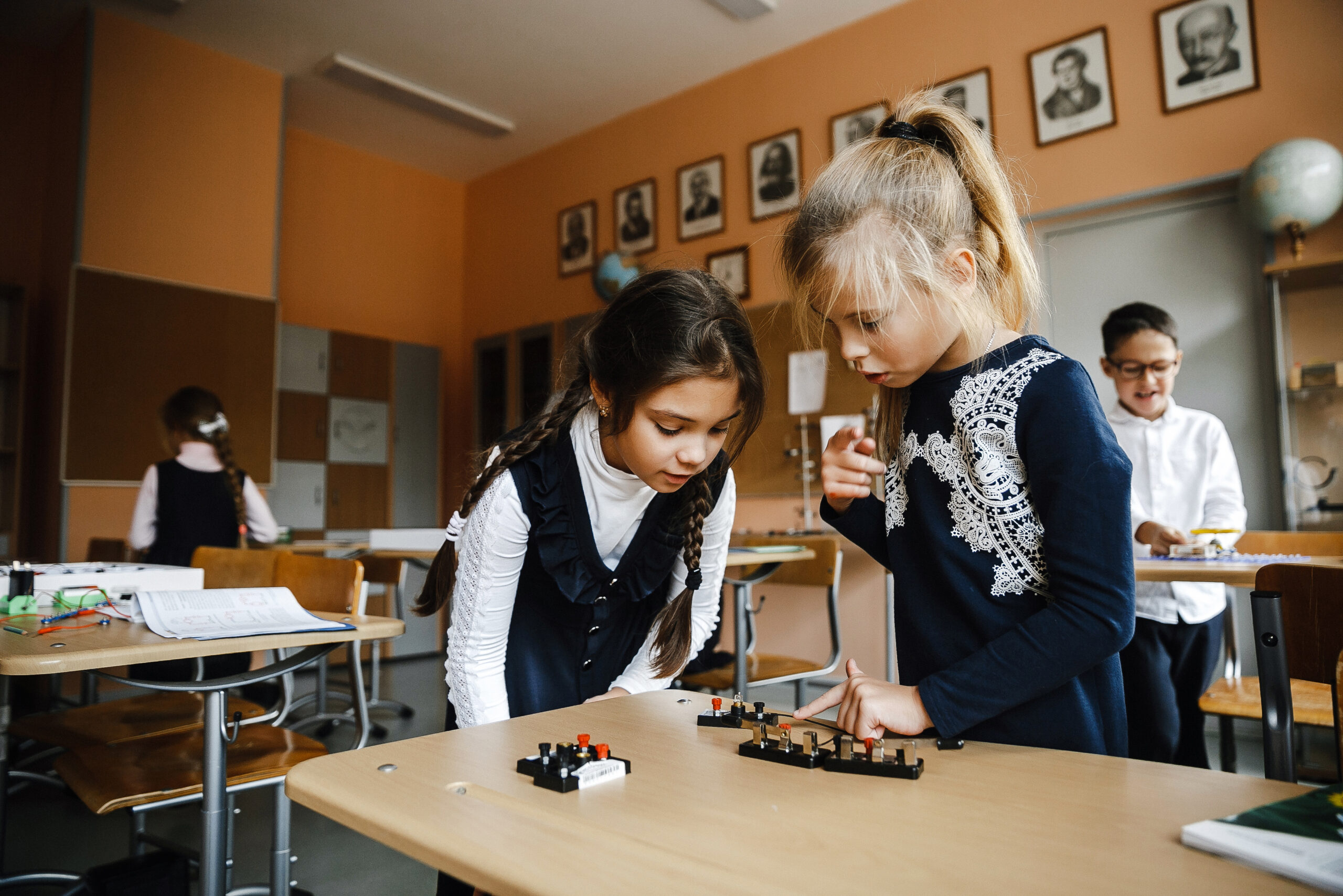 Students assembling an electrical circuit during physics class at school