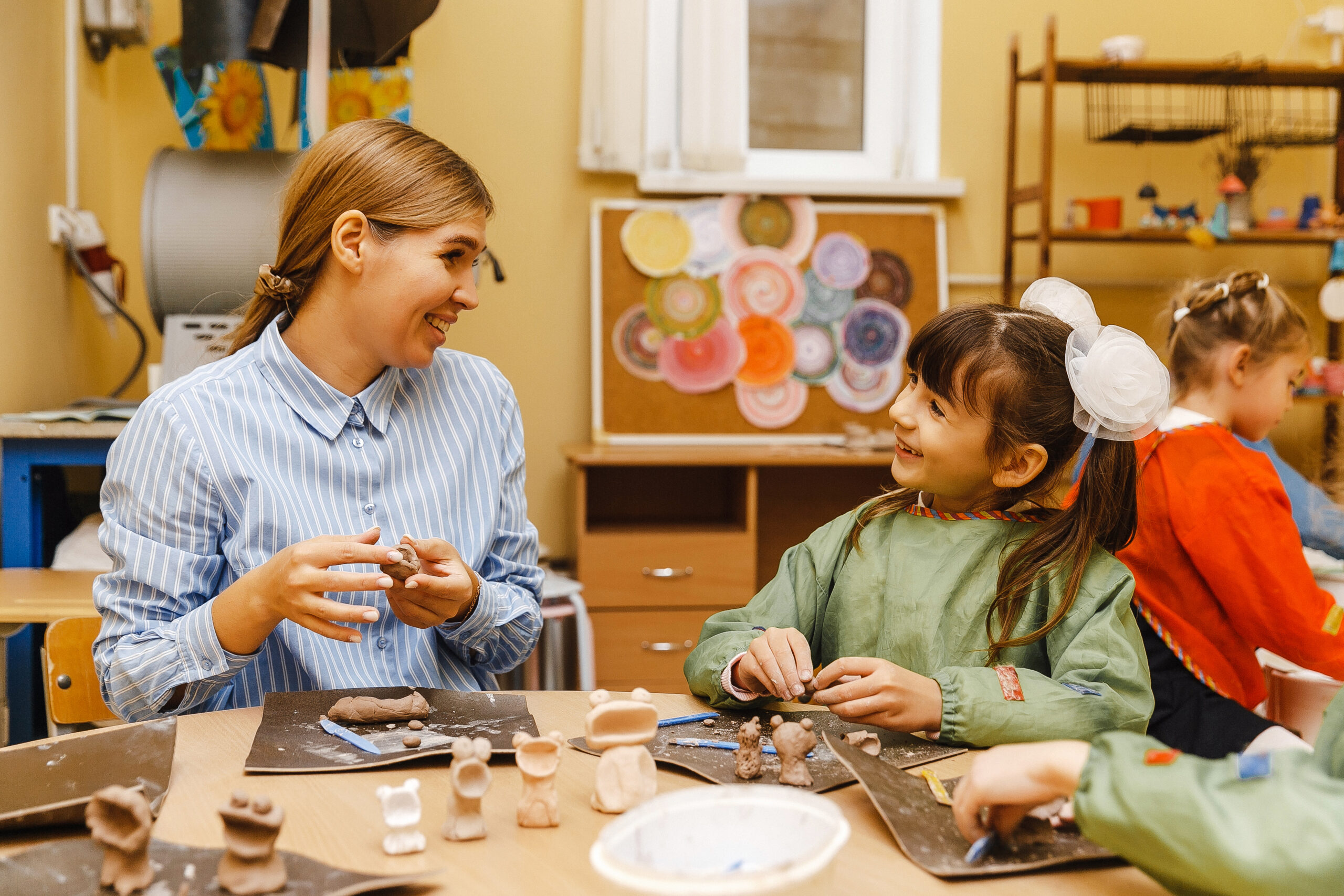 Students create clay figurines during a creative modeling lesson at school
