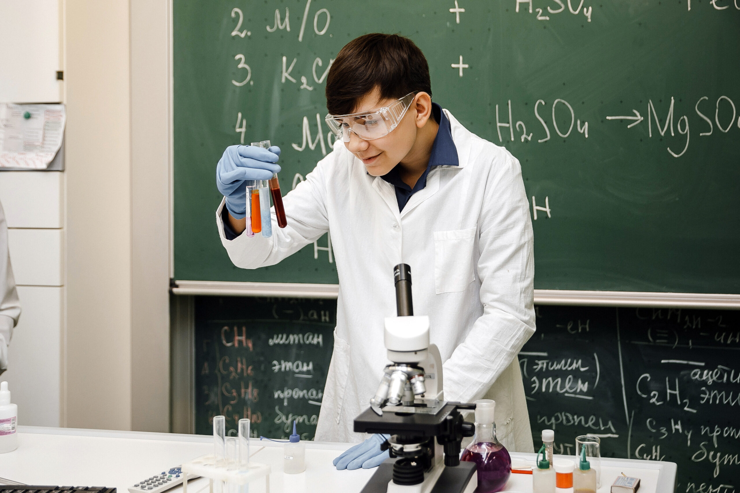Student conducting a chemistry experiment in the school laboratory
