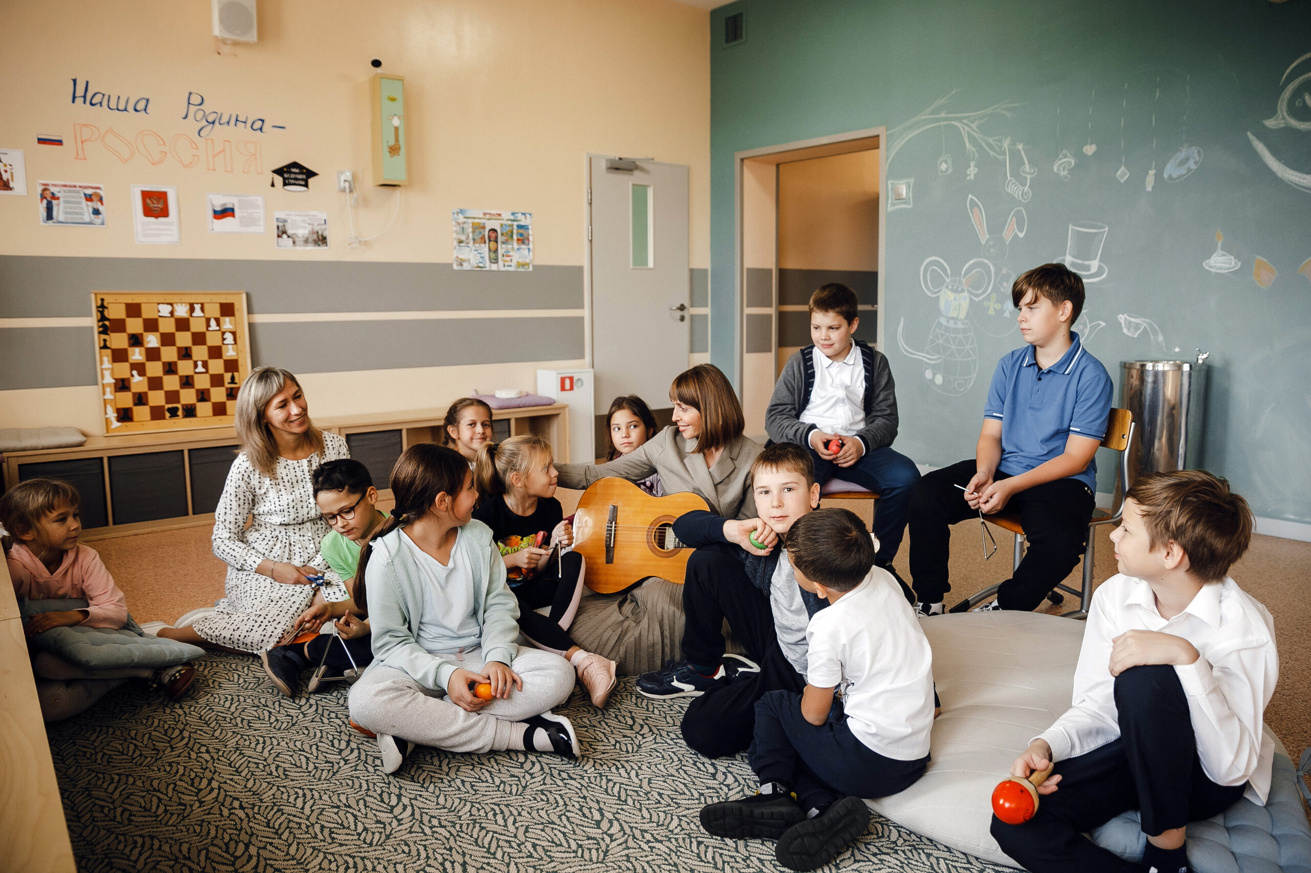 Students attending a musical activity with guitar and games