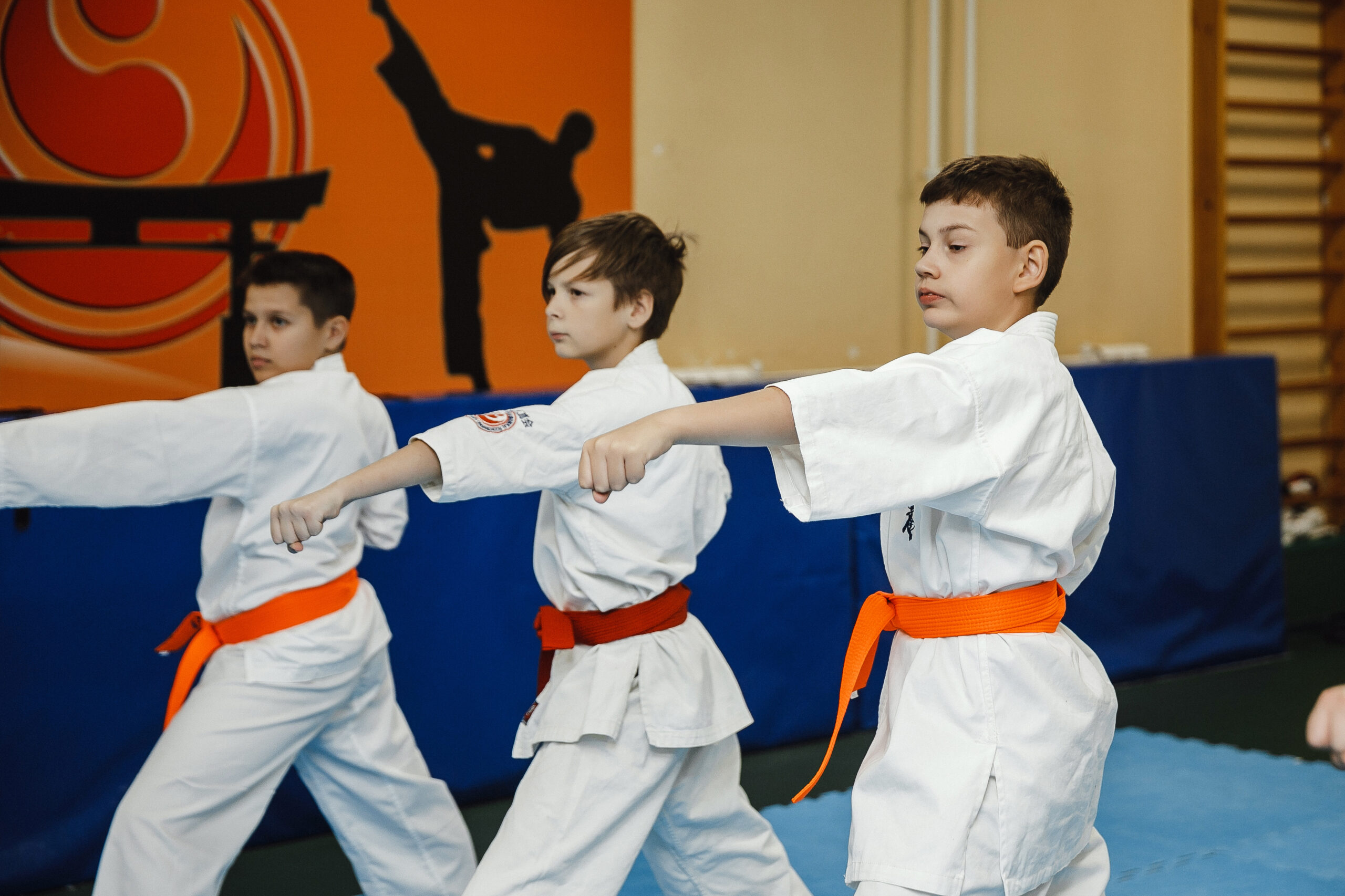 Students performing karate exercises in the gym