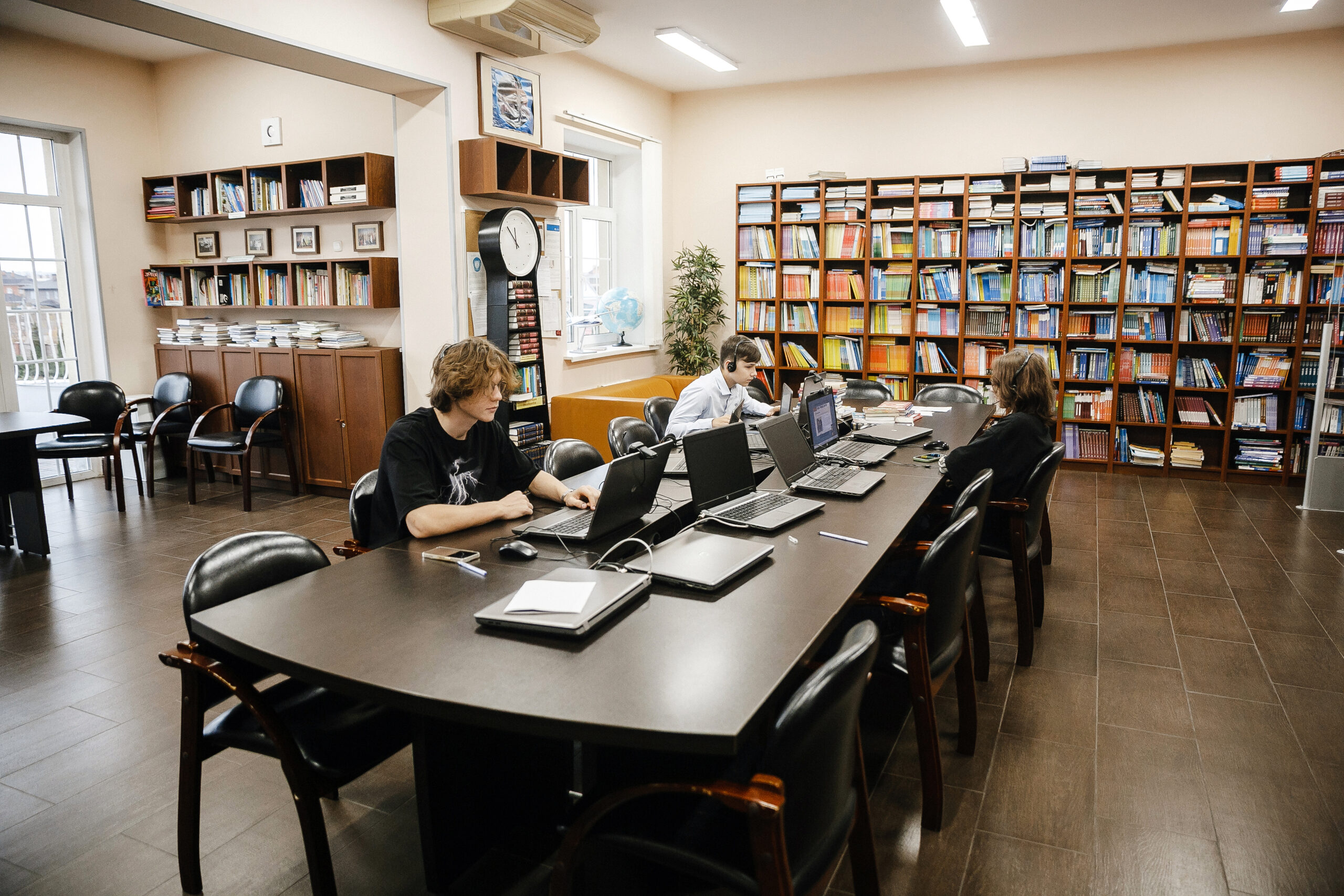 Students working on laptops in school library