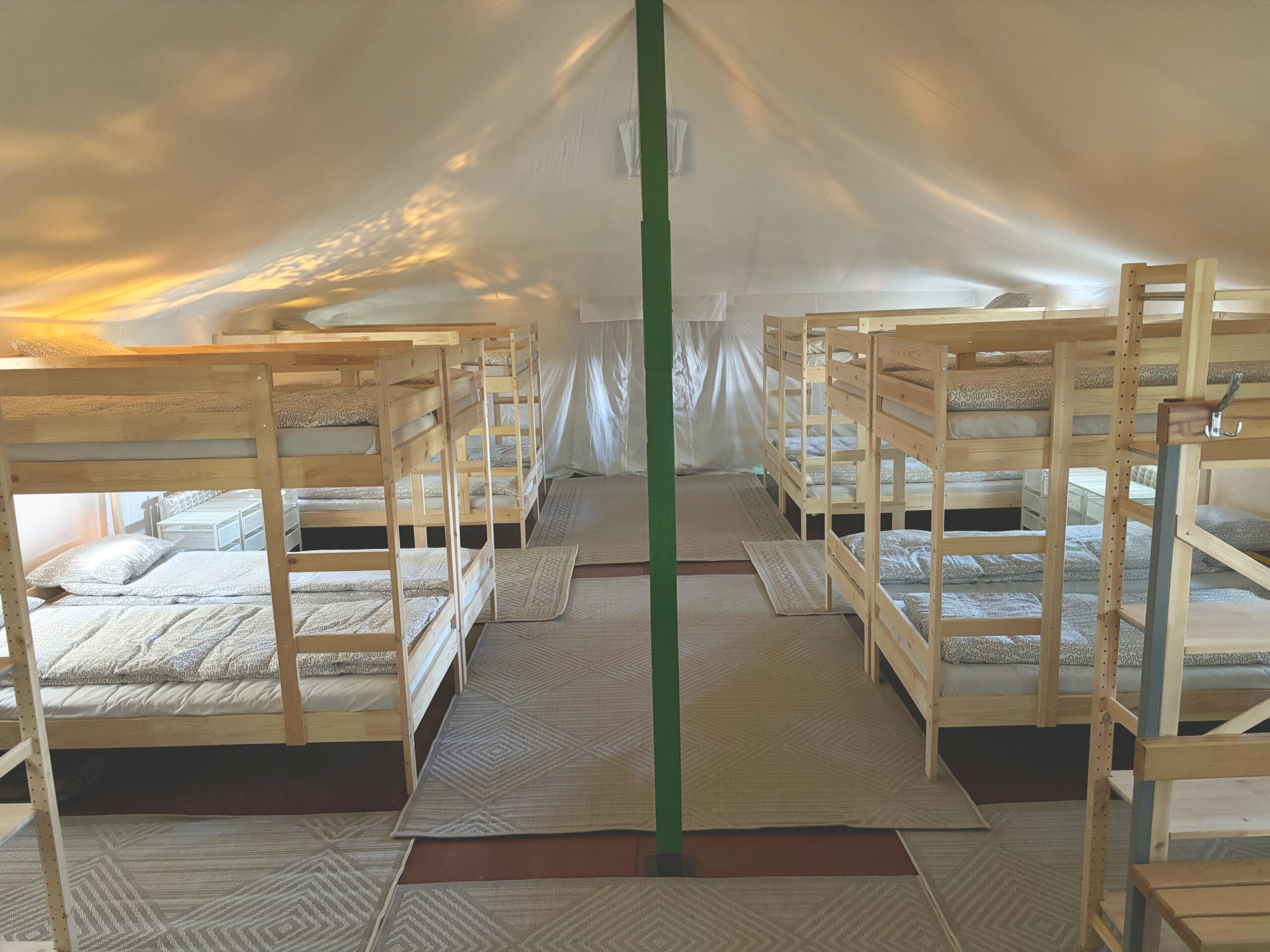 Cozy sleeping area in a children’s tent camp with bunk beds