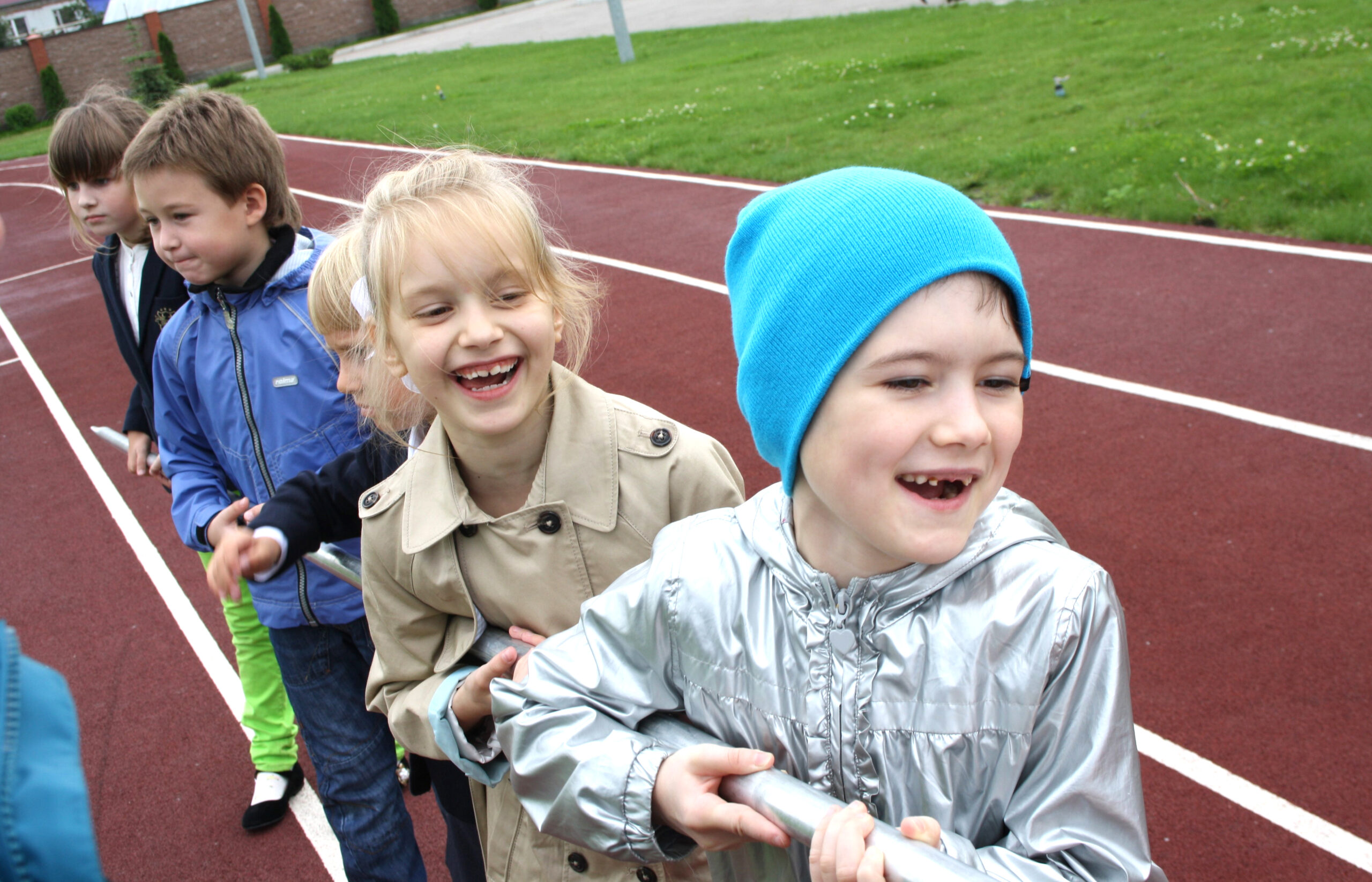 Happy children playing on the sports ground during a school event
