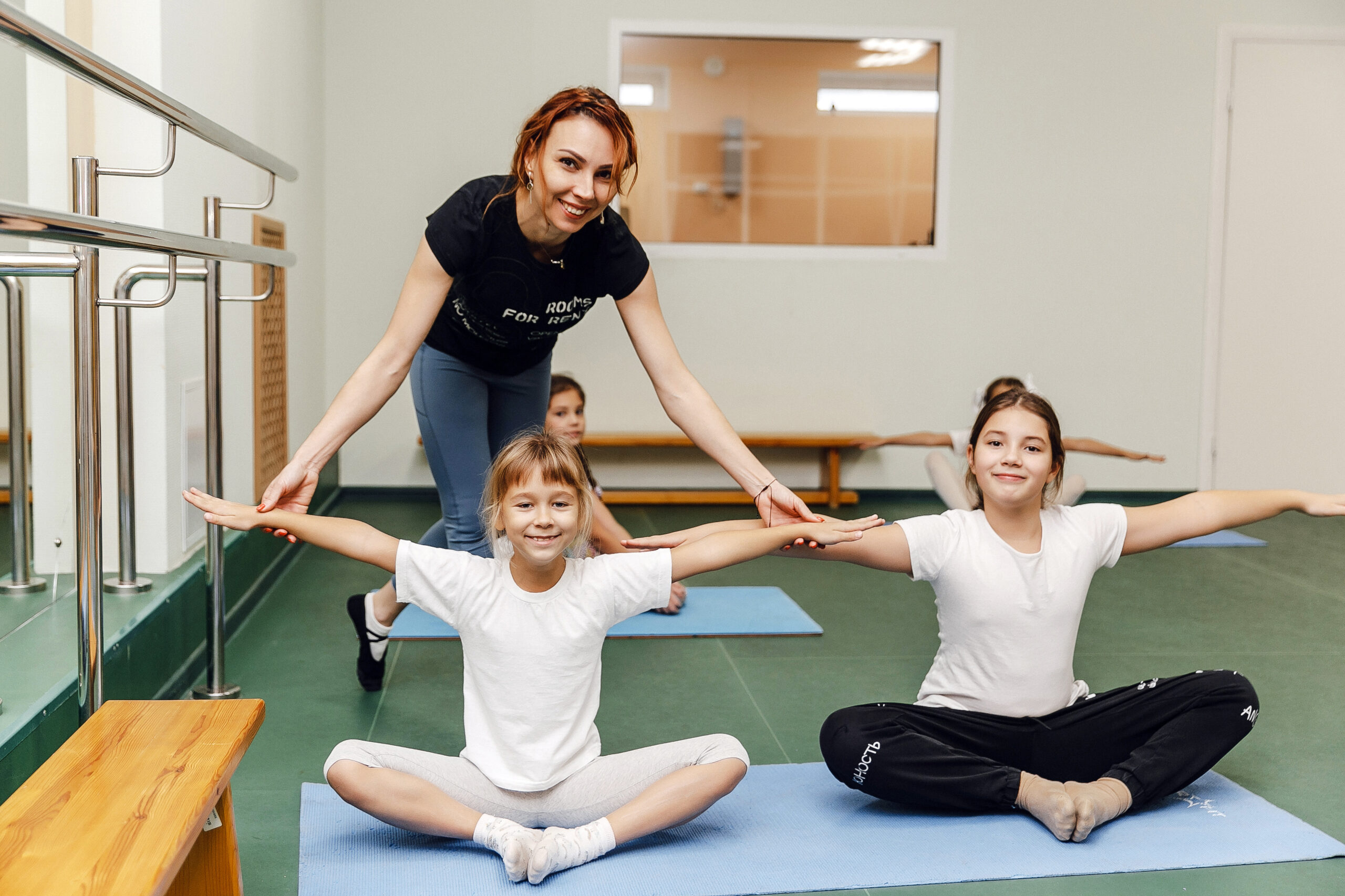 Yoga class for children with instructor in school gym